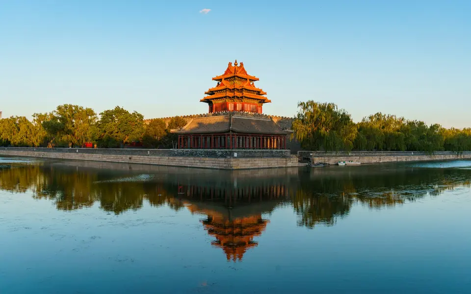 A corner tower of the Forbidden City reflected in the palace moat